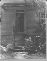 SA0126 - An unidentified woman in a doorway to a building; perhaps from the New Lebanon, NY Shaker community., Winterthur Shaker Photograph and Post Card Collection 1851 to 1921c